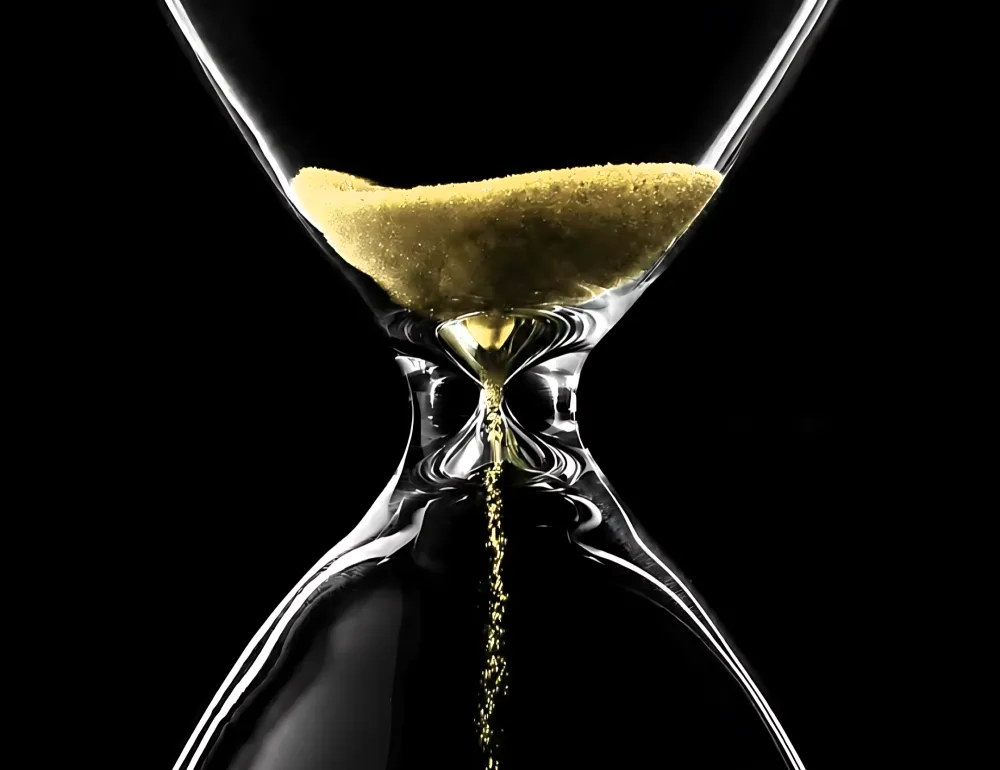 An hourglass with gold sand running out